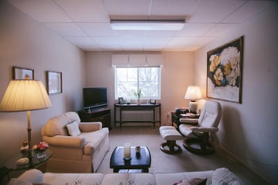 Cozy interior sitting area with lamps and a window