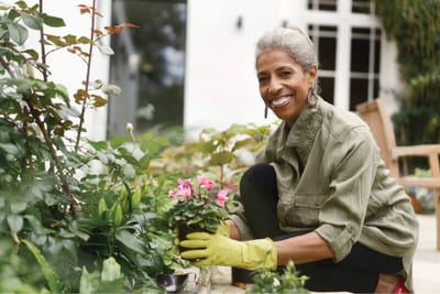 A resident gardening in the outdoor area