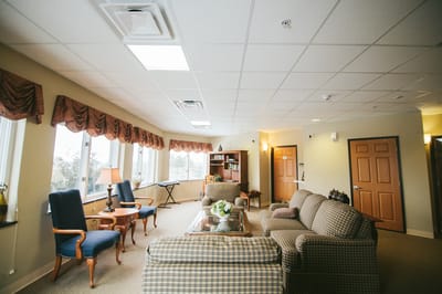 A cozy common area with seating and windows