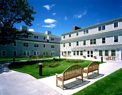 Outdoor seating area with benches and gardens