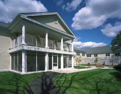 Exterior view of a senior living facility with gardens