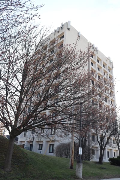 Exterior view of a multi-story assisted living facility with trees