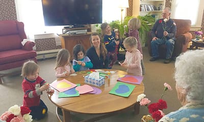 Children and a staff member engaged in arts and crafts activity