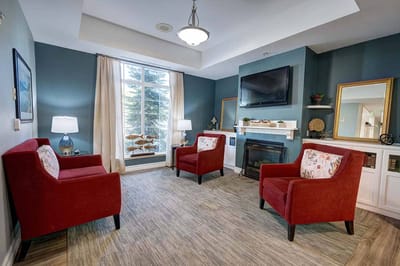 Bright lounge area with red chairs and natural light