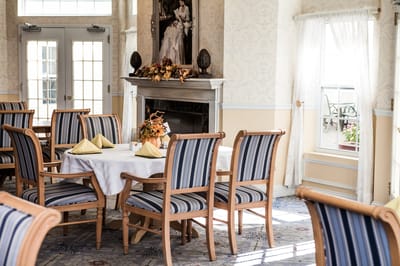 Elegant dining room setup with flowers and table settings