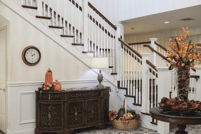 Interior hallway with decorative autumn display and clock