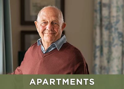Senior resident posing in a well-lit interior