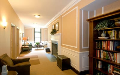 Interior hallway with seating and bookshelves