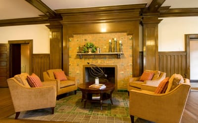 Cozy common area with chairs and a fireplace