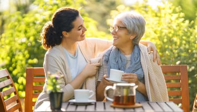 Resident and staff member enjoying tea outdoors