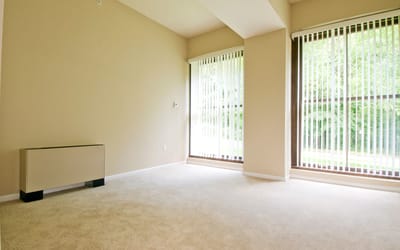 Interior view of a spacious room with large windows