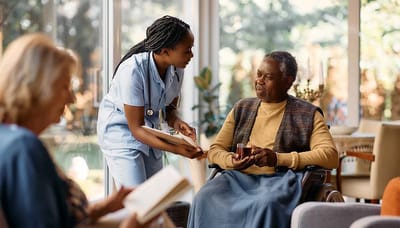 Nurse assisting a resident in a cozy common area