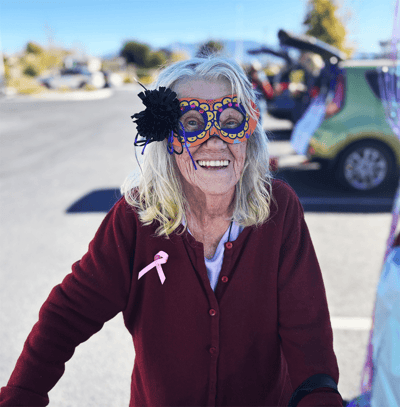 Resident wearing colorful glasses in a parking lot