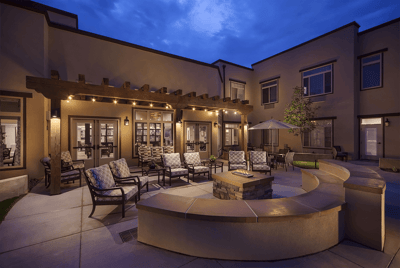 Cozy outdoor seating area with fire pit and patio lights