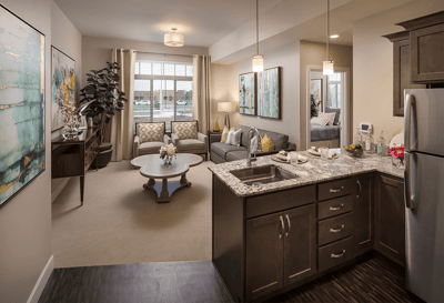 Bright, well-furnished living room area of an assisted living facility