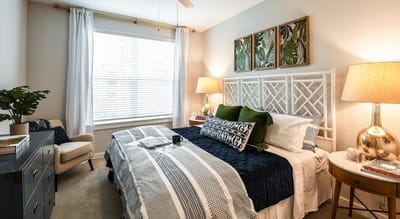 Brightly decorated resident bedroom with plants and artwork.