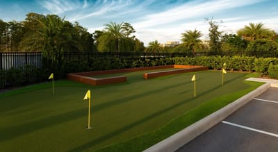 Well-maintained outdoor putting green with flags