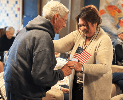 A staff member celebrating with a resident in a common area