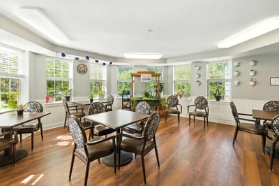 Bright dining area with large windows and plants