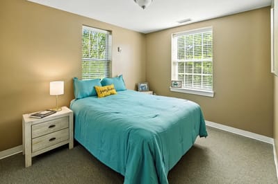 Cozy resident room with a bed and bedside table