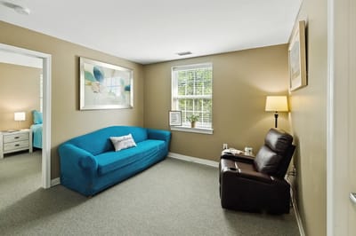 Cozy interior of a resident room with a blue sofa