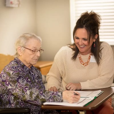 Staff member assisting a resident with paperwork