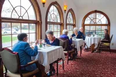 Residents enjoying a meal in a dining room