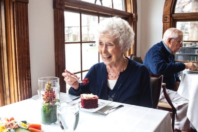 Resident enjoying a meal in a dining area