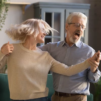 Residents dancing joyfully in an activity area