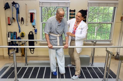 Therapist assisting a resident with rehabilitation