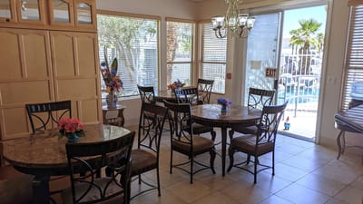 Bright common area with tables and view of outdoor pool