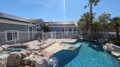Outdoor pool area with fencing and solar panels