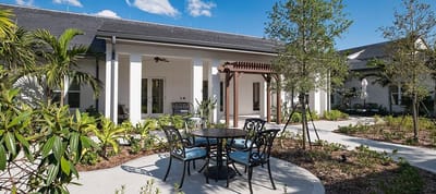 Outdoor seating area with tables and landscaping