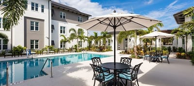 Outdoor pool area with seating and umbrellas