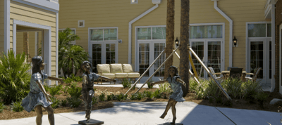 Outdoor courtyard with decorative statues and seating
