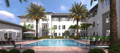 Outdoor pool area with palm trees and seating