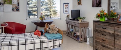 Cozy resident room with personal items and flowers