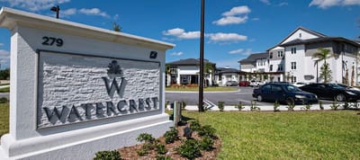 Facility entrance sign with the Watercrest logo