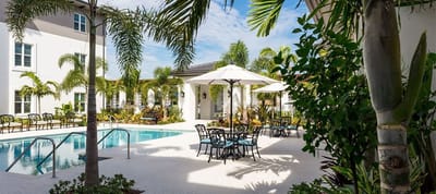 Outdoor pool area with seating and umbrellas