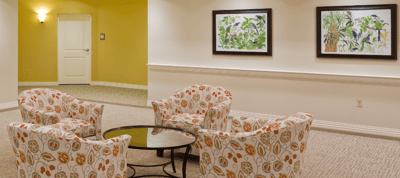 Cozy seating area with colorful chairs and artwork