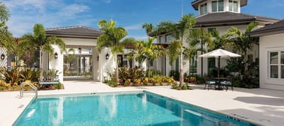 Outdoor pool area with tropical landscaping