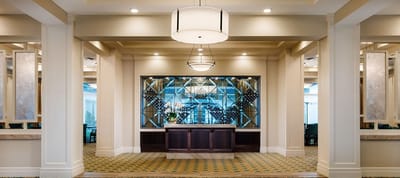 Bright lobby area with a reception desk and modern decor