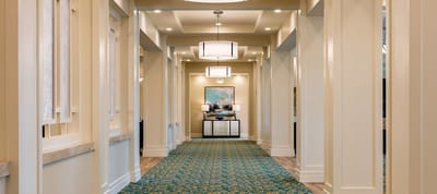 Well-lit hallway with decorative lighting and artwork