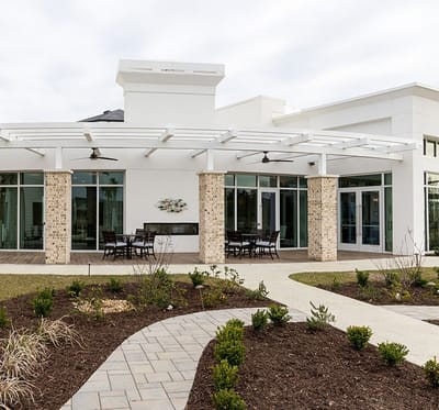 Exterior view of a modern facility entrance with outdoor seating
