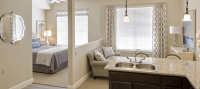Interior view of a resident's suite with a bedroom and living area