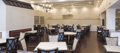 Dining room setup with empty tables and chairs