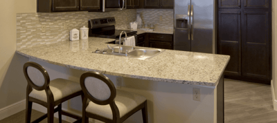 Modern kitchen area with granite countertops