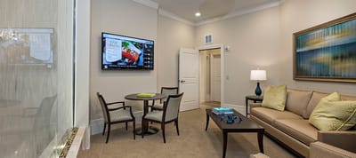 A cozy common area with seating and a TV