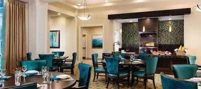 A bright dining room with tables set for meals
