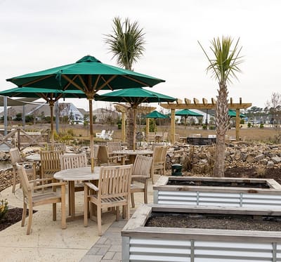 Outdoor seating area with tables and umbrellas